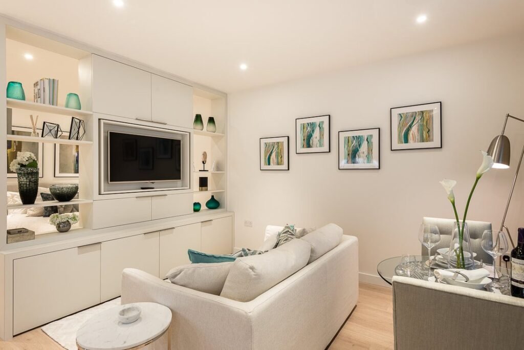 New build lounge with recessed downlights and lit shelving