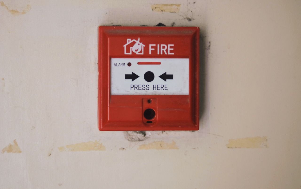 Manual fire alarm call point on a wall